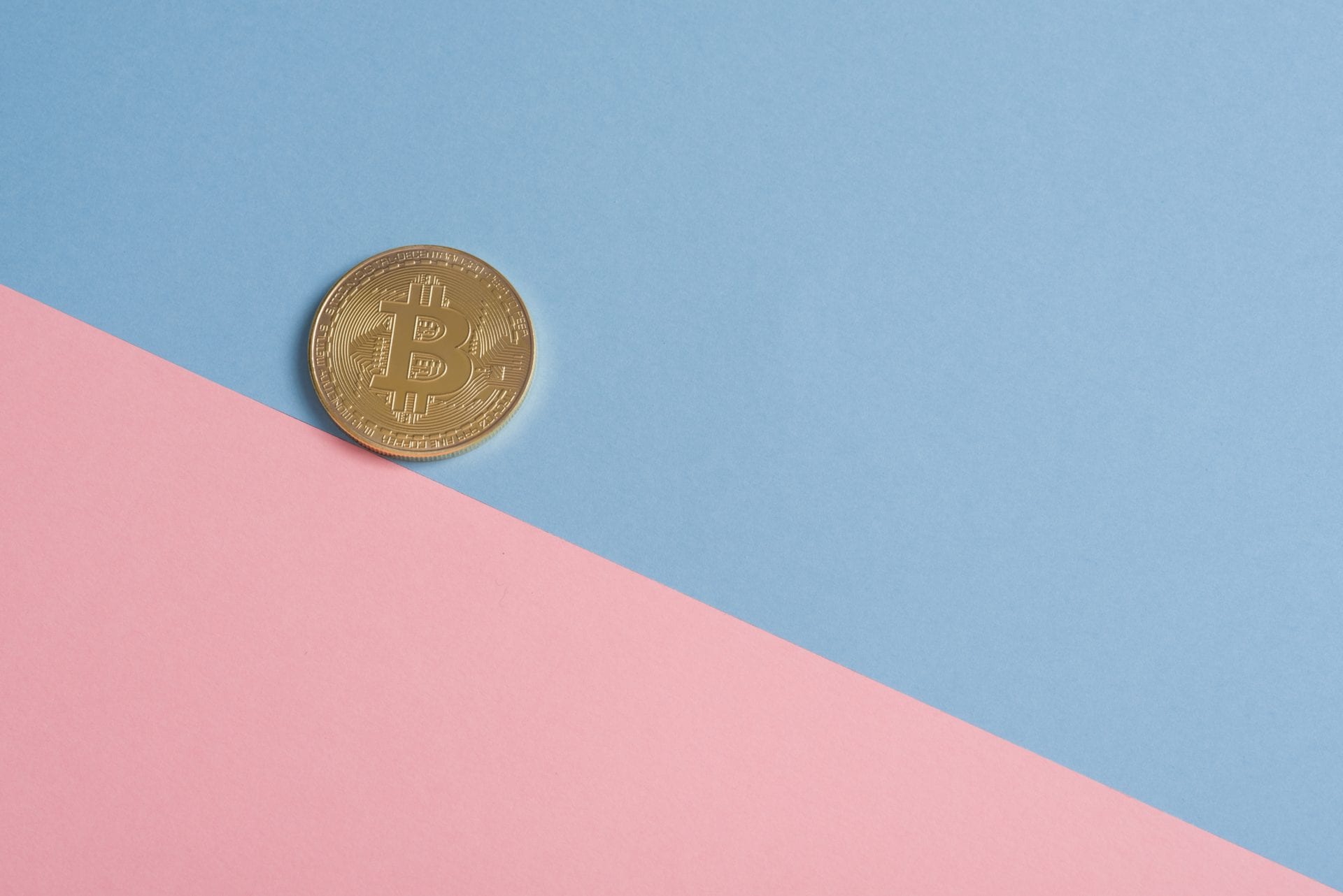 a bitcoin with pink blue background
